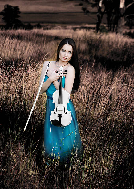 istock Young woman holds violin 179997015