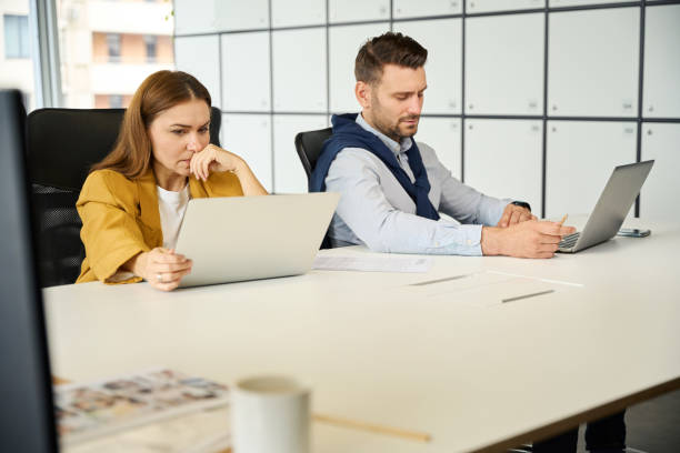 istock Upset managers are sitting at their workplaces 1799983674