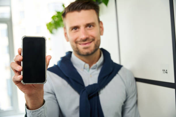 istock Young man with a mobile phone stands at storage lockers 1799983694
