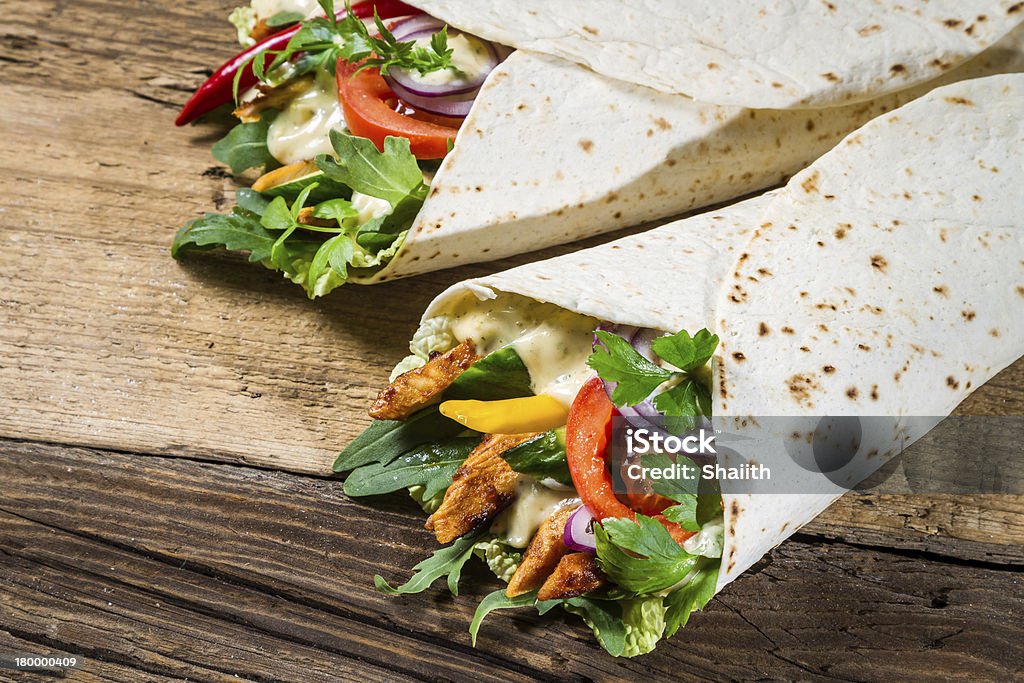 Kebab in a pancake with vegetables and chicken Kebab in a pancake with vegetables and chicken. Alcohol - Drink Stock Photo