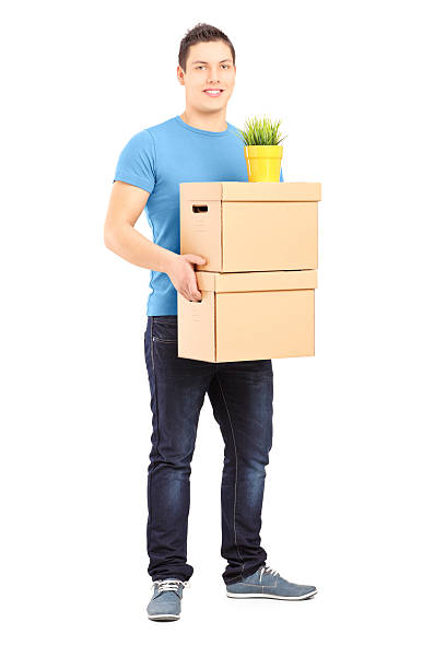 istock Guy carrying removal boxes during moving into a new house 180001417