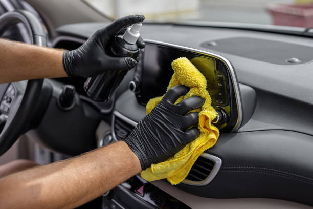 hand cleaning the car interior with microfiber cloth towel - car cleaning inside of indoors imagens e fotografias de stock