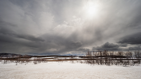Winter storm sweeping over a sunny Canadian frozen lake landscape. Olympus E-500 DSLR.