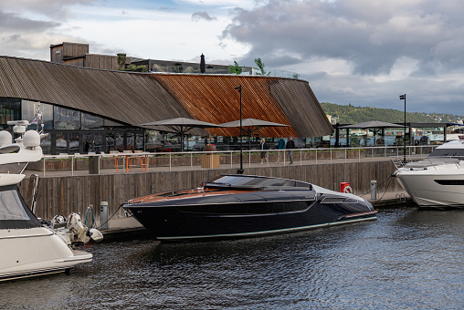 Oslo, Norway - August 13, 2023: A picture of a speedboat at the Aker Brygge Marina.