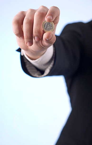 istock Man with one euro coin 180007037
