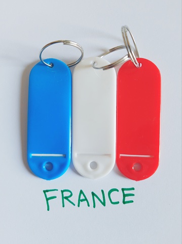 Three colors key chains forming the French flag. Flag of France with vertical strips of blue, white and red. flag symbols of France on white background. French republic