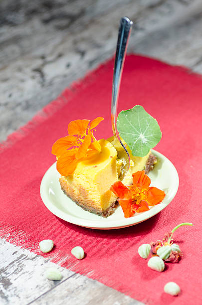 istock Slice of pumpkin cheesecake on red napking, blured background 180009404