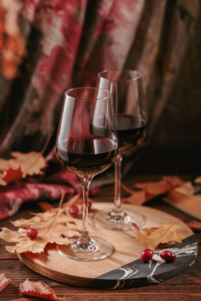 istock Autumn still life with wine, book and dry leaves 1800106079