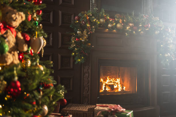 istock Classical Christmas decorated interior living room library with fireplace. Christmas tree with red golden ornament decorations. Modern classic style interior design apartment. Christmas eve at home. 1800117941