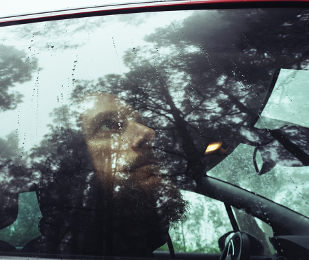 Man in car outdoor in forest