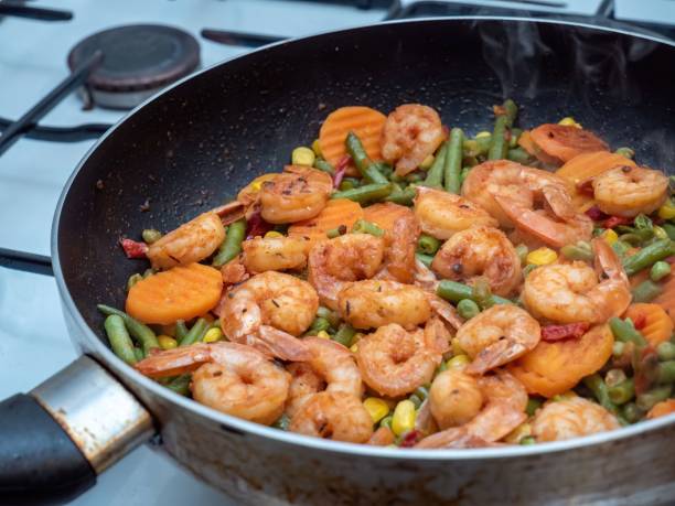 istock Closeup of a pan with shrimp and vegetables 1800141262