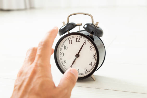 istock Hand stopping alarm clock alarm 1800160992