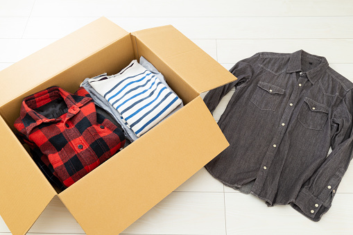 Cardboard box filled with clothes