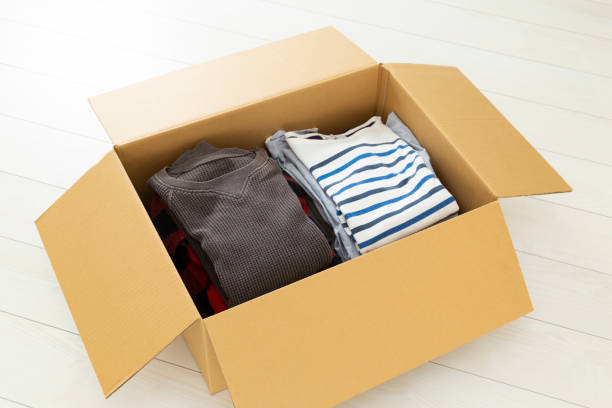 istock Cardboard box filled with clothes 1800164650
