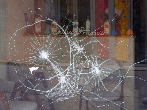 Grenoble, France - October 1, 2023: Consequences of vandalism - a broken window of a shop