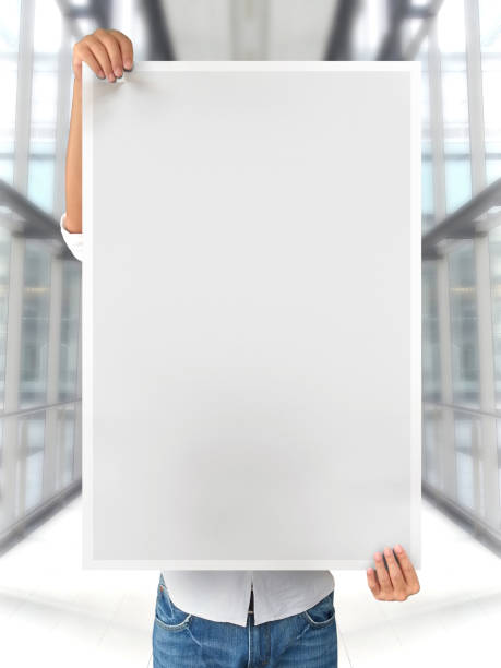 istock A Woman Holding an Empty Poster Mockup 1800176125