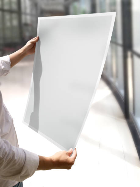 istock A Woman Holding an Empty Poster Mockup 1800176652