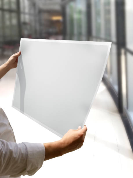 istock A Woman Holding an Empty Poster Mockup 1800176656