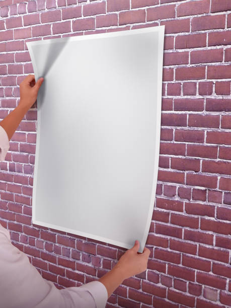 istock A Woman Holding an Empty Poster Mockup 1800177171