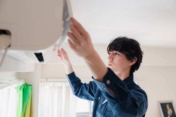 istock A man inspecting an air conditioner 1800178233