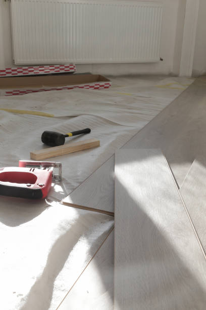 istock Rubber hammer, ruler with angle bar, tape meter, jig saw and other tools for installation of laminate vinyl floor. Home improvement, new floor installation. 1800205567