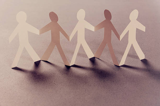 istock Group of paper people holding hands. Teamwork concept 180026964
