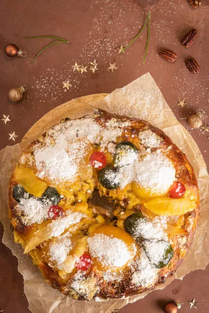 Bolo Rei or Kings Cake is a traditional Xmas cake with fruits raisins nut and icing on kitcthen countertop. Is made for Christmas, Carnavale or Mardi Gras