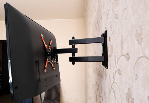 istock Swivel TV bracket LED display. Back view. X-shaped red fasteners. Black color. Multiplanar. Hangs on a wall. Reliable and comfortable fastening. Childproof and rollover protection. Metallic equipment 1800311900