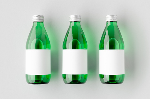 Water bottle mockup with a blank label. Green glass.
