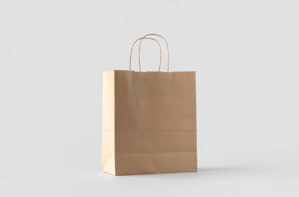 istock Kraft paper bag with handles, blank mockup isolated on a grey background. 1800324098
