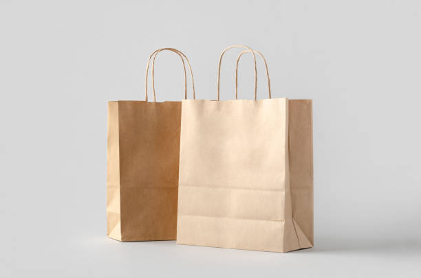 istock Kraft paper bag with handles, blank mockup isolated on a grey background. 1800326595