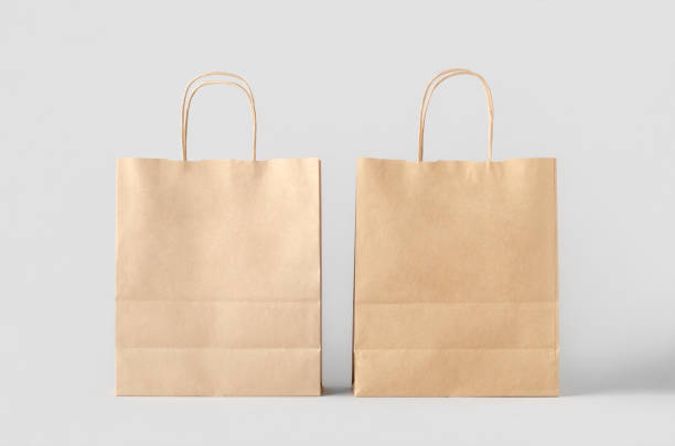 istock Kraft paper bag with handles, blank mockup isolated on a grey background. 1800326676