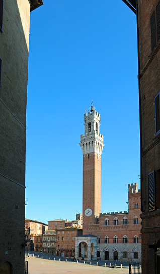 Siena, SI, Italy - February 20, 2023: Tower called Torre del Mangia in the main square Piazza del Campo