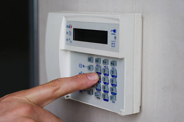 istock Finger pressing keys on alarm keypad 180033659