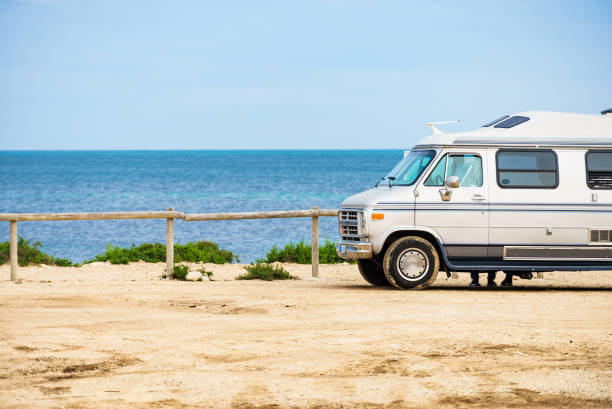 istock American van on beach seashore. Holidays trip. 1800355663