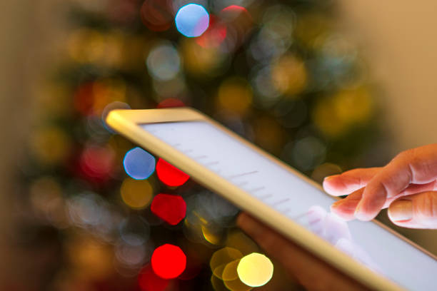 istock Using the Tablet in front of the Christmas tree 1800374978