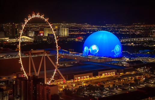 New MSG Sphere in Las Vegas next to High Roller wheel at night