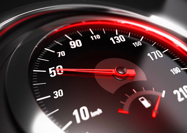 Reducing Speed Safe Driving Concept - 50 Km h Close up of a car speedometer with the needle pointing 50 Km h, blur effect, conceptual image for safe driving concept speedometer photos stock pictures, royalty-free photos & images