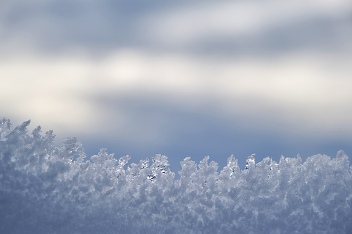 Ice crystals texture after snowfall, wintry nature background, selective focus