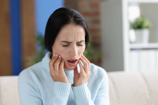 istock Young woman with severe acute toothache closeup 1800422632