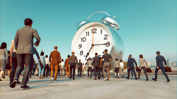 istock Workers in Business Attire Face Off Against a Massive Alarm Clock 1800443631