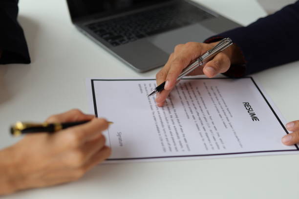 istock Manager reading resume while interviewing new employee candidates in office, job interview. 1800445056
