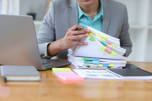 istock Businessman working on paperwork on the desk in the office. 1800445112