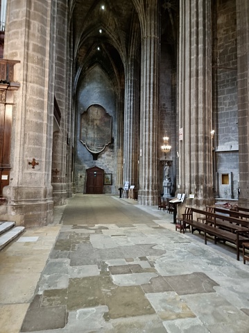 Narbonne Cathedral is a Roman Catholic church located in the town of Narbonne, France. The cathedral is a national monument and dedicated to Saints Justus and Pastor. The image shows the interior of the gothic church.