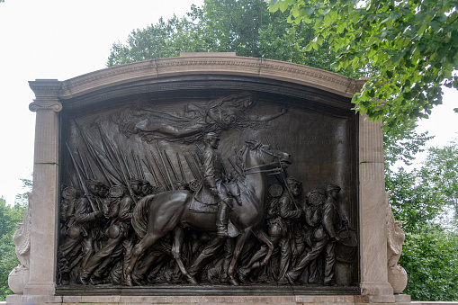 The Memorial to Robert Gould Shaw by Augustus Saint-Gaudens opposite the State Capitol Building on Boston Common). Robert Gould Shaw is seen leading members of the 54th Regiment Massachusetts Volunteer Infantry 1863. The sculpture was unveiled on May 31, 1897. the first civic monument to pay homage to the heroism of African American soldiers.