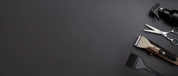 istock Stylish professional barber scissors, hair cutting shears on black background. Various shaving and bauty care accessories placed on black background 1800518870