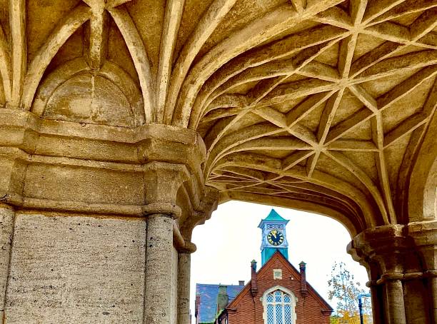 Leighton Buzzard clock tower A different perspective of the clock tower in Leighton Buzzard viewed through the recently cleaned and renovated Market Cross. leighton buzzard stock pictures, royalty-free photos & images
