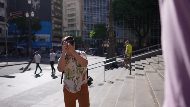 Mature man photographing in a city