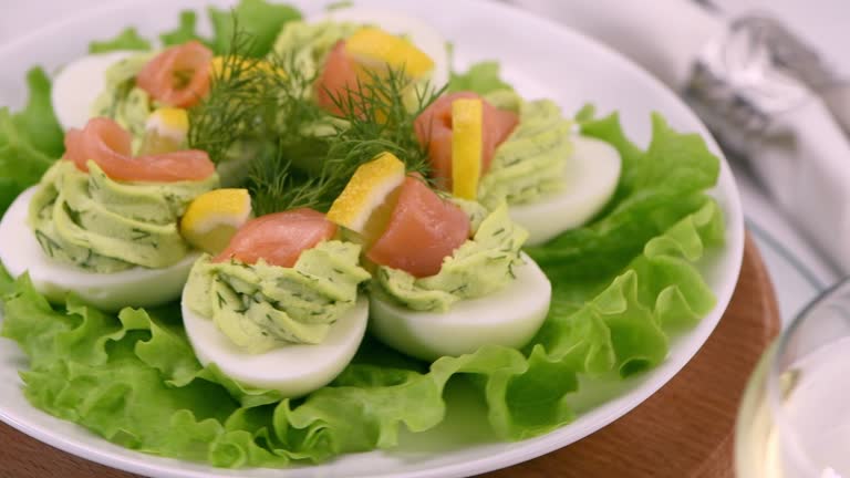 Stuffed eggs with avocado and salmon