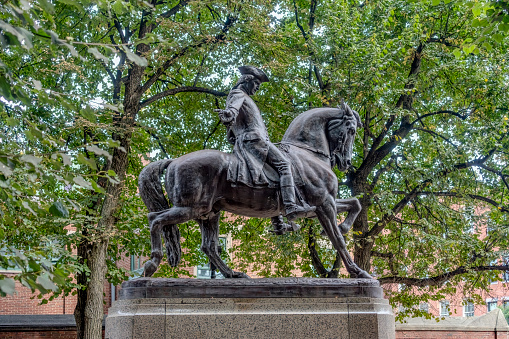 Paul Revere Mall in downtown Boston, Massachusetts.  In the foreground is the statue of Paul Revere and in the background is Old North church.  It was the lanterns in the spire that alerted the revolutionaries to the British arrival.\n\nThe statue of Paul Revere is by Cyrus Edwin Dallin is installed in Boston's Paul Revere Mall near the Old North Church in the U.S. state of Massachusetts. The sculpture was modelled in 1885.